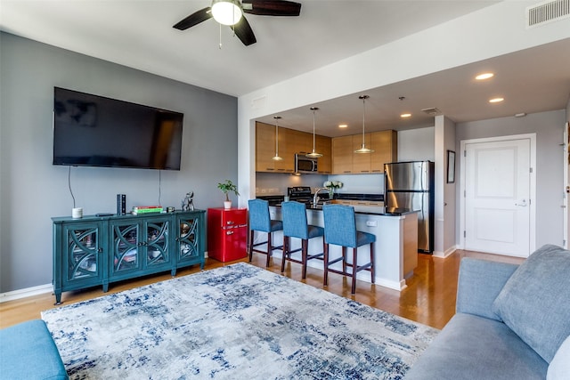 1200 Main St Unit 1402, Dallas, TX 75202 - living area featuring a ceiling fan, wood finished floors, and recessed lighting