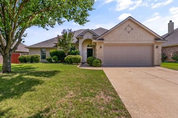 521 Willowview Dr, Saginaw, TX 76179 - view of front of house with a garage, driveway, a front lawn, and brick siding
