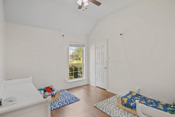 521 Willowview Dr, Saginaw, TX 76179 - bedroom with lofted ceiling, wood finished floors, and a ceiling fan