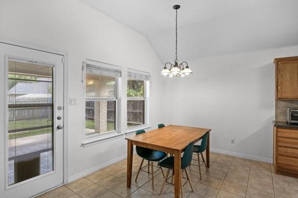 521 Willowview Dr, Saginaw, TX 76179 - dining area with plenty of natural light, vaulted ceiling, a chandelier, and light tile patterned flooring