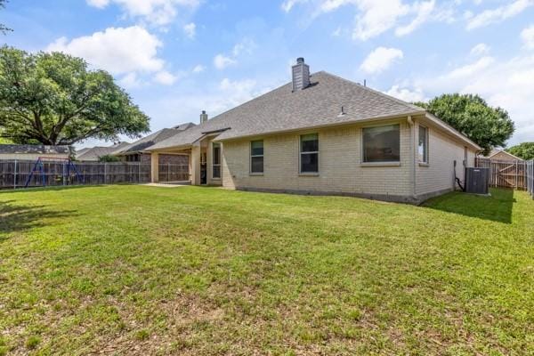 521 Willowview Dr, Saginaw, TX 76179 - rear view of property featuring a chimney, a fenced backyard, and brick siding