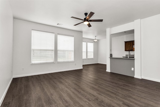 2142 Stonebrook Ln, Mesquite, TX 75181 - unfurnished living room featuring a ceiling fan and dark wood-type flooring