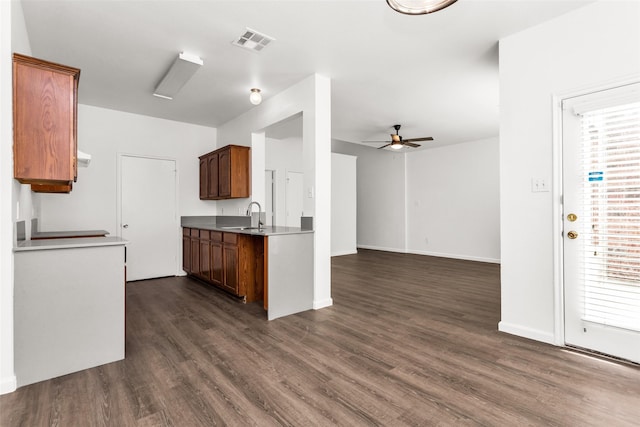 2142 Stonebrook Ln, Mesquite, TX 75181 - kitchen featuring dark wood-type flooring, ceiling fan, brown cabinets, and open floor plan
