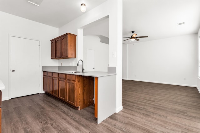 2142 Stonebrook Ln, Mesquite, TX 75181 - kitchen featuring a ceiling fan, dark wood-style floors, light countertops, and brown cabinets
