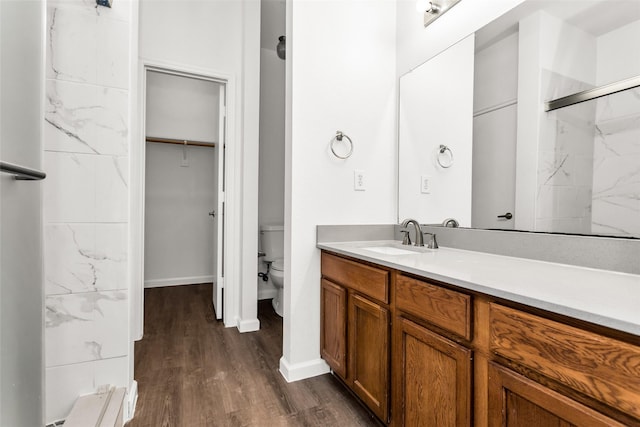 2142 Stonebrook Ln, Mesquite, TX 75181 - full bathroom featuring wood finished floors, vanity, a marble finish shower, and a walk in closet