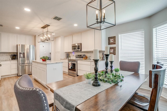 705 Tracy Dr, Azle, TX 76020 - dining area featuring a chandelier, light wood-style floors, and recessed lighting