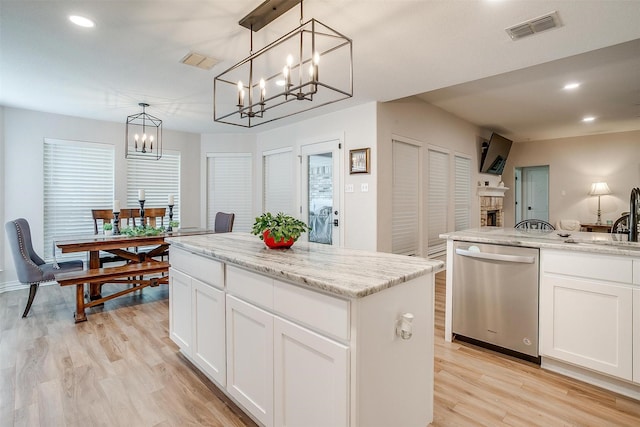 705 Tracy Dr, Azle, TX 76020 - kitchen featuring stainless steel dishwasher, a chandelier, light wood-style flooring, a kitchen island, and white cabinetry