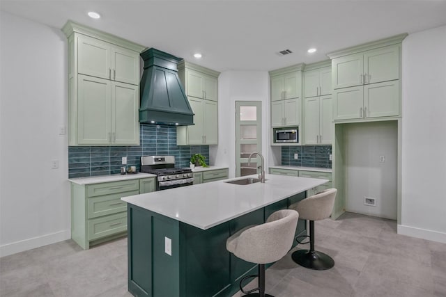 510 Woodrow Ave, Fort Worth, TX 76105 - kitchen featuring green cabinets, custom exhaust hood, appliances with stainless steel finishes, decorative backsplash, and light countertops