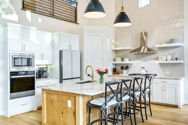 3915 Lochwood Dr, Rowlett, TX 75088 - kitchen with stainless steel appliances, wall chimney exhaust hood, open shelves, light stone counters, and a high ceiling