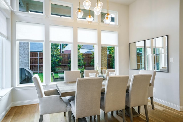 3915 Lochwood Dr, Rowlett, TX 75088 - dining room featuring wood finished floors and a towering ceiling