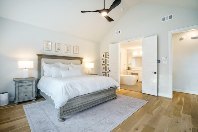 3915 Lochwood Dr, Rowlett, TX 75088 - bedroom with high vaulted ceiling, wood finished floors, ensuite bath, and ceiling fan