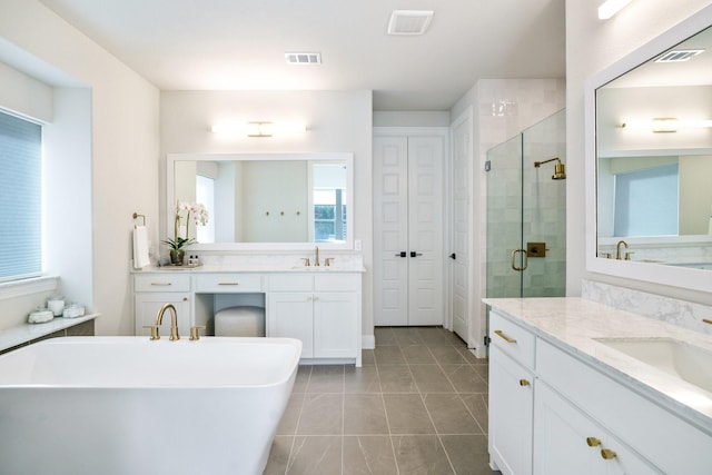 3915 Lochwood Dr, Rowlett, TX 75088 - full bath with a shower stall, a freestanding tub, two vanities, and tile patterned floors