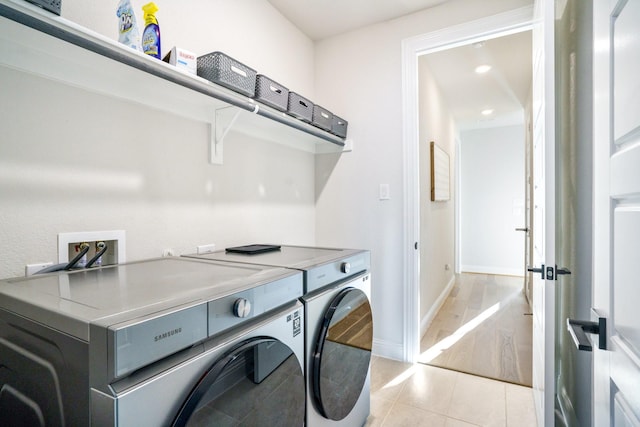 3915 Lochwood Dr, Rowlett, TX 75088 - laundry room featuring independent washer and dryer and light tile patterned floors