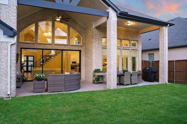 3915 Lochwood Dr, Rowlett, TX 75088 - back of property at dusk featuring an outdoor living space, a patio area, ceiling fan, and brick siding