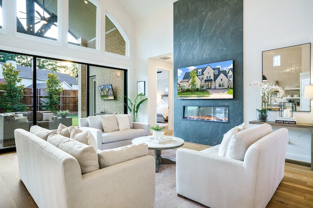 3915 Lochwood Dr, Rowlett, TX 75088 - living room with a high ceiling, wood finished floors, and a fireplace