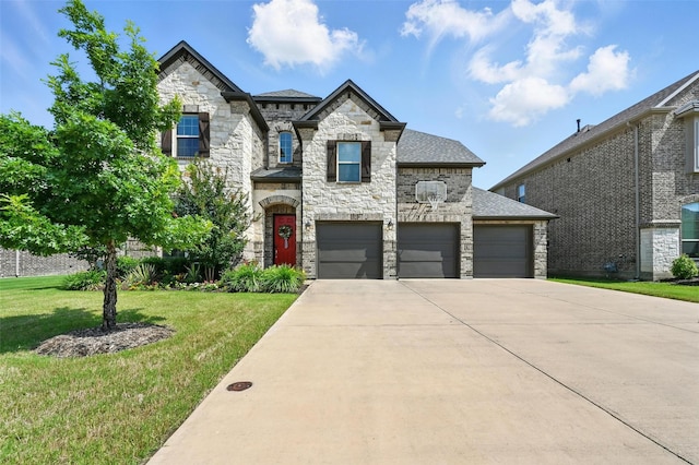 2711 Fleur De Lis Ln, Grand Prairie, TX 75054 - french country home featuring stone siding, concrete driveway, a front yard, a garage, and roof with shingles
