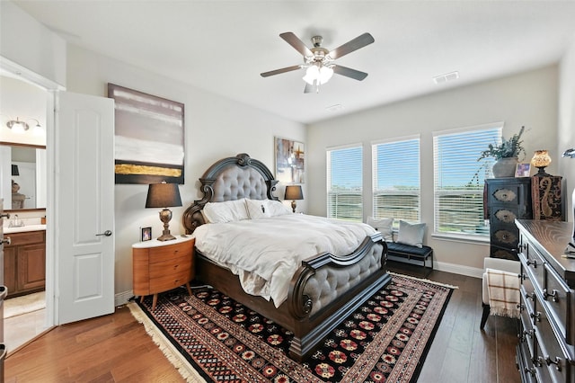 2711 Fleur De Lis Ln, Grand Prairie, TX 75054 - bedroom with dark wood-style floors, ceiling fan, and ensuite bath