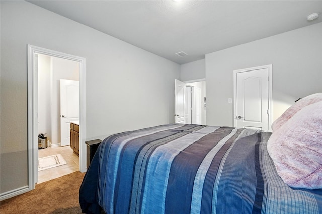 2711 Fleur De Lis Ln, Grand Prairie, TX 75054 - carpeted bedroom with connected bathroom and baseboards