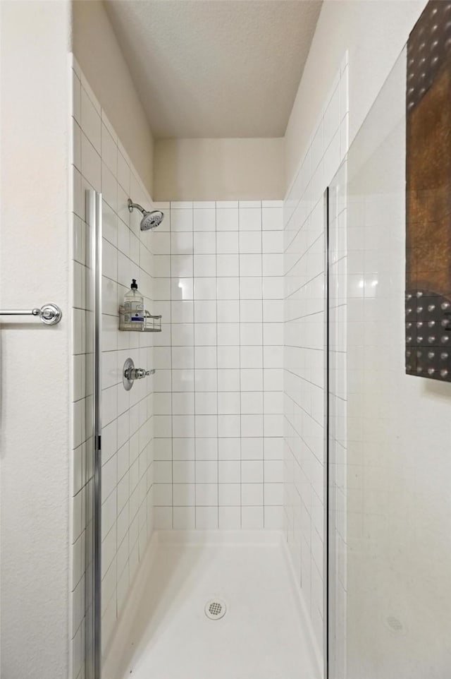 2711 Fleur De Lis Ln, Grand Prairie, TX 75054 - bathroom featuring a stall shower and a textured ceiling