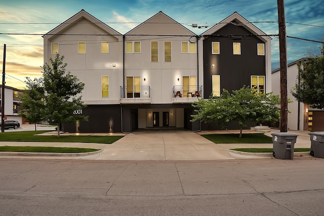 2001 N Prairie Ave Unit 106, Dallas, TX 75204 - view of front of house featuring a carport, french doors, concrete driveway, and a balcony