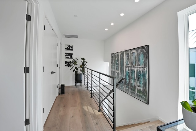 2001 N Prairie Ave Unit 106, Dallas, TX 75204 - hallway with an upstairs landing, recessed lighting, and light wood-style floors