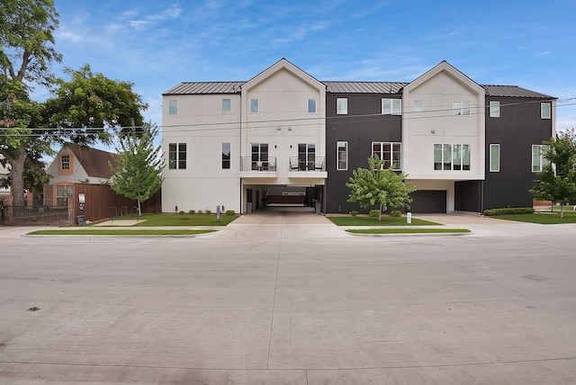 2001 N Prairie Ave Unit 106, Dallas, TX 75204 - view of front of home with a metal roof, driveway, an attached garage, and stucco siding