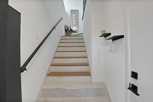 2001 N Prairie Ave Unit 106, Dallas, TX 75204 - stairs featuring marble look tile flooring and baseboards