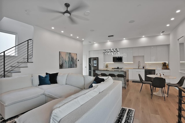 2001 N Prairie Ave Unit 106, Dallas, TX 75204 - living room with recessed lighting, light wood finished floors, a ceiling fan, and stairs