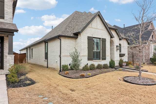 8128 Legacy Trl, Mckinney, TX 75071 - view of side of property with roof with shingles and brick siding