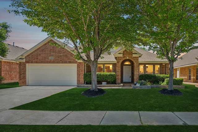 2020 El Camino Dr, Fort Worth, TX 76177 - view of front facade featuring concrete driveway, an attached garage, a front lawn, roof with shingles, and brick siding