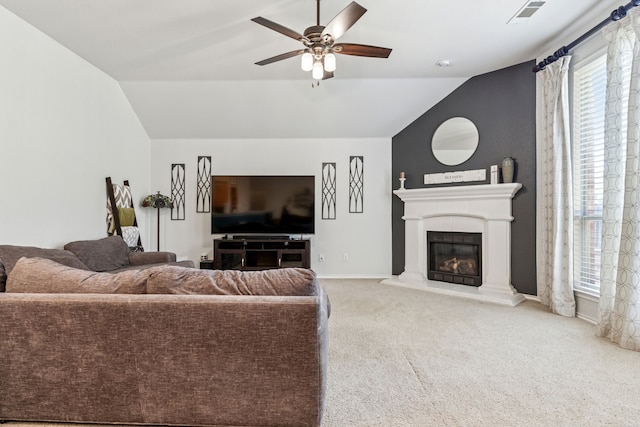 2020 El Camino Dr, Fort Worth, TX 76177 - carpeted living room with lofted ceiling, a ceiling fan, and a glass covered fireplace
