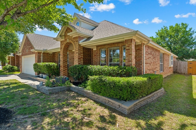 2020 El Camino Dr, Fort Worth, TX 76177 - traditional-style house with brick siding, an attached garage, roof with shingles, and driveway