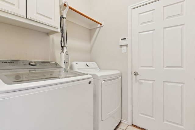 2020 El Camino Dr, Fort Worth, TX 76177 - laundry area with cabinet space, washer and clothes dryer, and light tile patterned floors