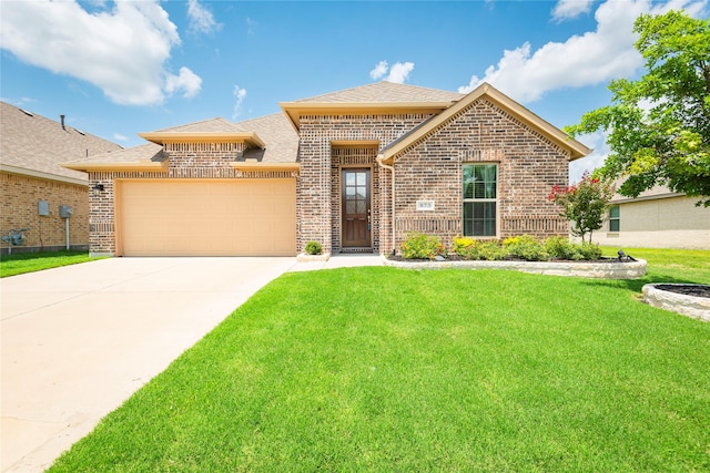 873 Mildren Ln, Fate, TX 75087 - view of front facade featuring brick siding, a front yard, a garage, driveway, and a shingled roof