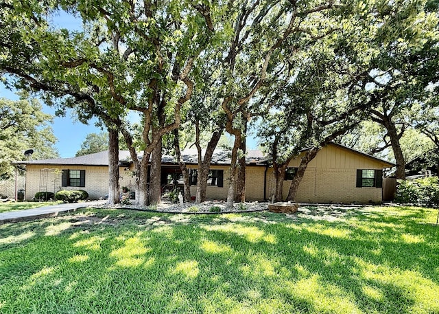 1705 14th St, Brownwood, TX 76801 - view of front of property featuring brick siding and a front yard