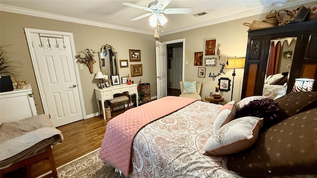 1705 14th St, Brownwood, TX 76801 - bedroom with wood finished floors, ornamental molding, and a ceiling fan