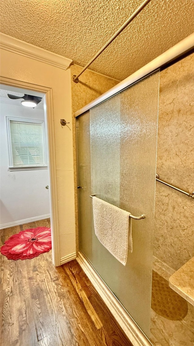 1705 14th St, Brownwood, TX 76801 - full bath with an enclosed shower, wood finished floors, and crown molding