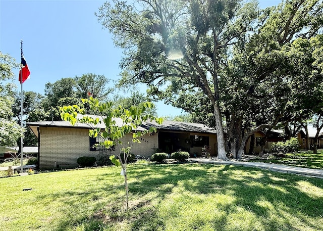 1705 14th St, Brownwood, TX 76801 - view of front of home with a front yard and brick siding