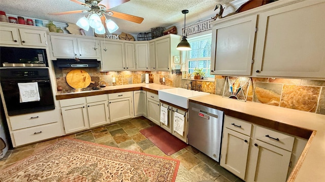 1705 14th St, Brownwood, TX 76801 - kitchen with black appliances, stone tile floors, under cabinet range hood, tasteful backsplash, and a ceiling fan