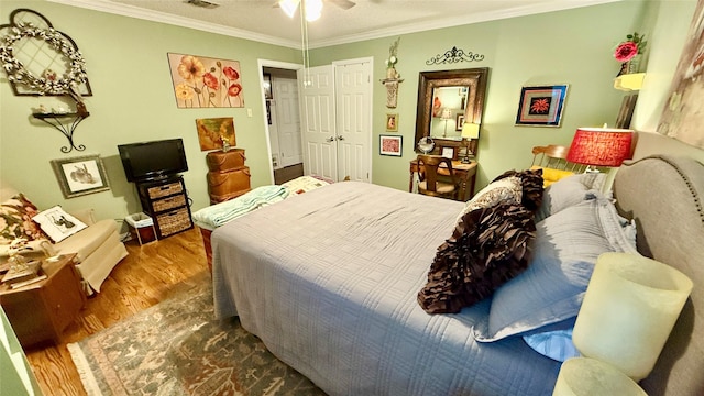1705 14th St, Brownwood, TX 76801 - bedroom with wood finished floors, ornamental molding, a closet, and a ceiling fan