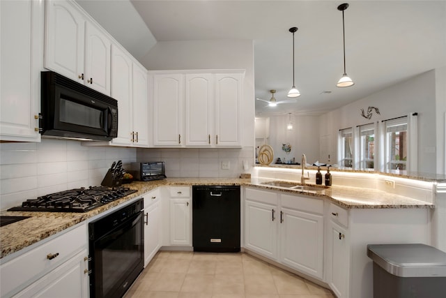 7585 Glasshouse Walk, Frisco, TX 75035 - kitchen with black appliances, tasteful backsplash, white cabinetry, and light stone countertops