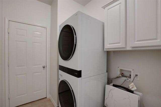 7585 Glasshouse Walk, Frisco, TX 75035 - laundry area with stacked washer / drying machine and cabinet space