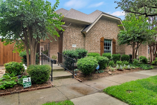 7585 Glasshouse Walk, Frisco, TX 75035 - view of front of home with brick siding and a shingled roof