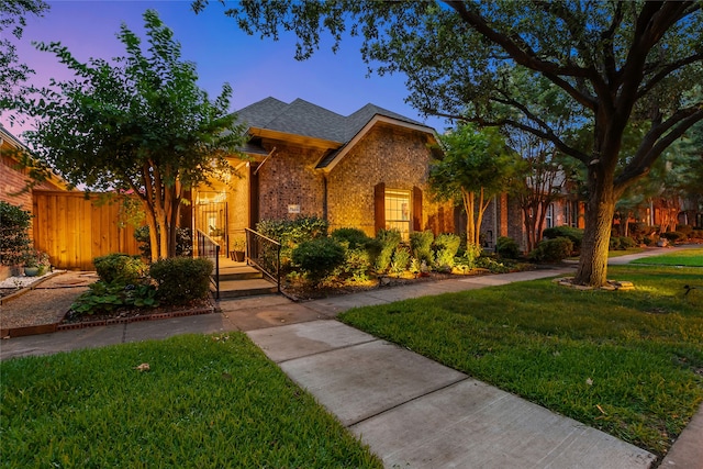 7585 Glasshouse Walk, Frisco, TX 75035 - view of front of property featuring a yard, brick siding, and a shingled roof
