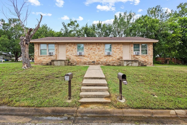 701 W Hull St Unit 101-2, Denison, TX 75020 - view of front of property featuring brick siding and cooling unit