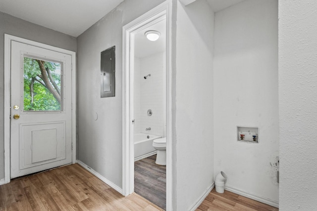701 W Hull St Unit 101-2, Denison, TX 75020 - washroom with washer hookup, electric panel, and wood finished floors