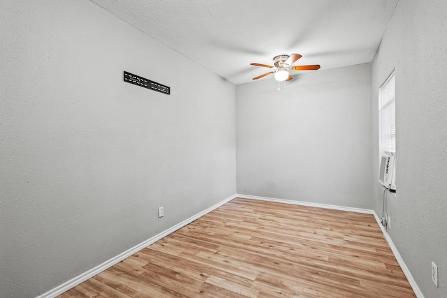701 W Hull St Unit 101-2, Denison, TX 75020 - spare room featuring ceiling fan, light wood-style flooring, and cooling unit