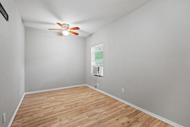 701 W Hull St Unit 101-2, Denison, TX 75020 - empty room featuring light wood-style flooring, ceiling fan, and cooling unit