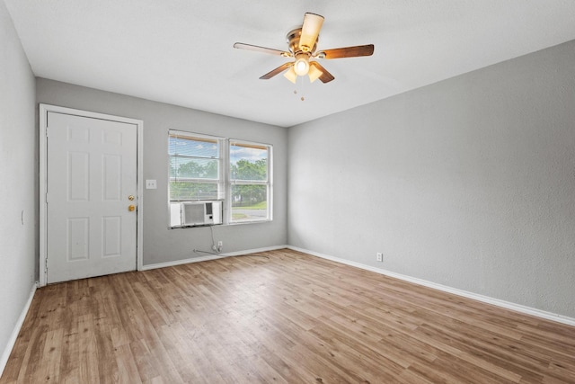701 W Hull St Unit 101-2, Denison, TX 75020 - unfurnished room with wood finished floors, cooling unit, and ceiling fan