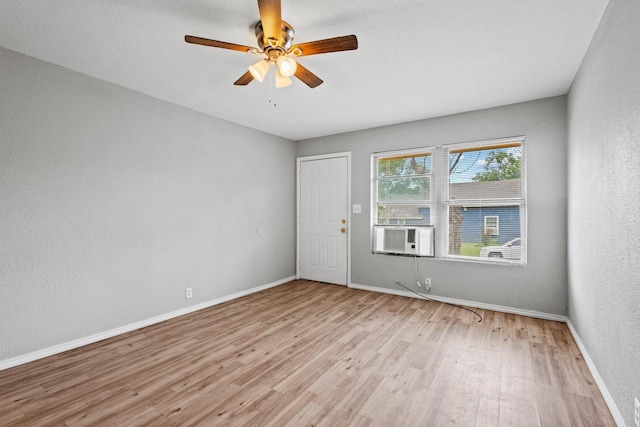 701 W Hull St Unit 101-2, Denison, TX 75020 - empty room featuring light wood-style flooring, a ceiling fan, a textured wall, and cooling unit